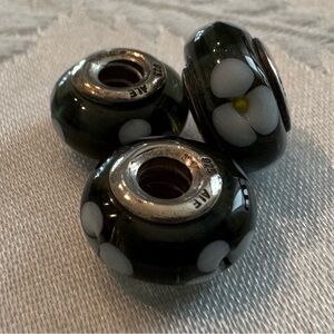 Black Glass Bead Charms with White Flower Design.